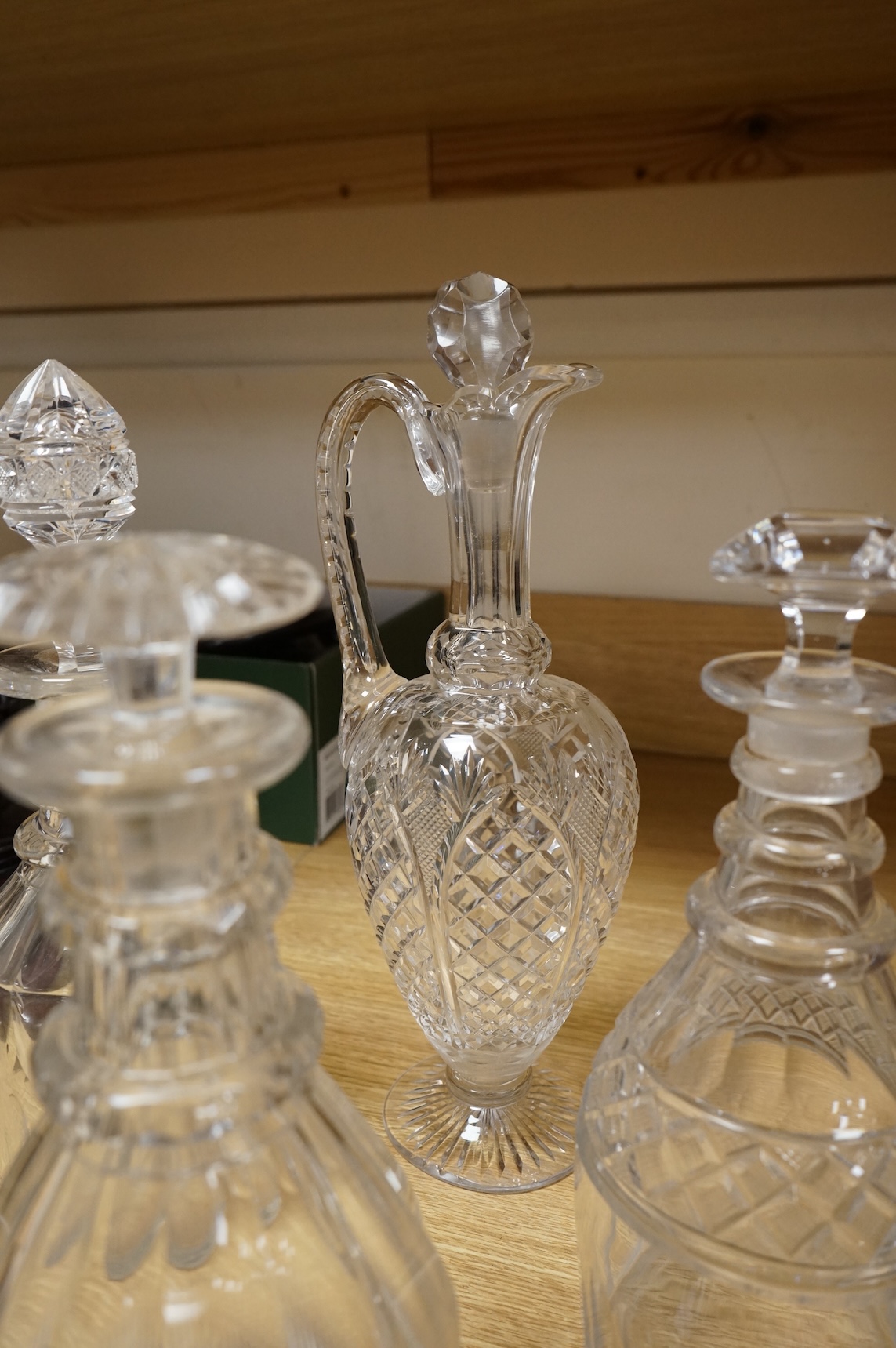 Three early 19th century cut glass decanters and two Victorian jugs, tallest 32cm